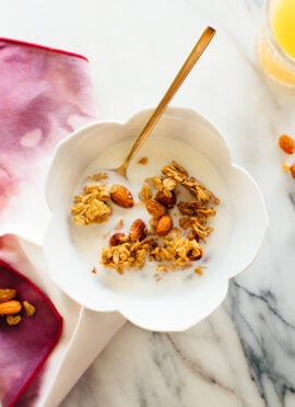 Orange almond granola in cereal bowl with milk